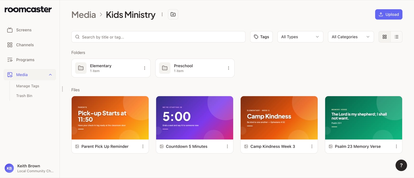 The Roomcaster Media Library open to a Kids Ministry folder, with Elementary and Preschool subfolders above slides for a countdown, a memory verse, and a pick-up reminder